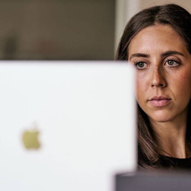 Photo of Sammi Stemmerman behind Laptop Working